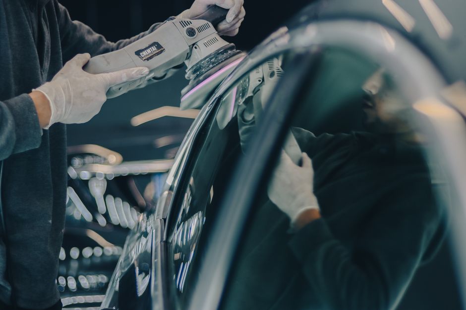 Auto detailing professional inspecting a vehicle